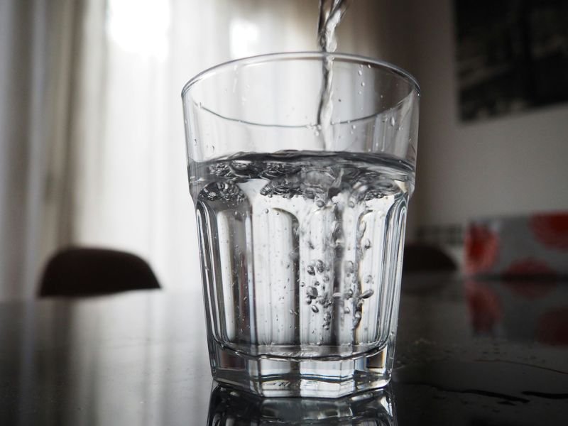 Pouring water into a glass — water is an uncountable noun