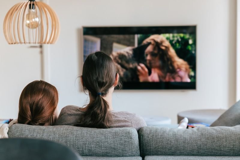 Two learners watching an English TV show to improve listening