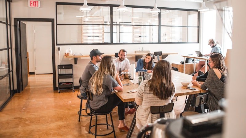 Coworkers talking in an office where work-safe American slang is common