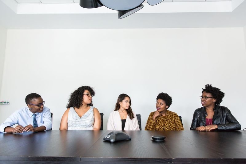 Business professionals using English in an office meeting