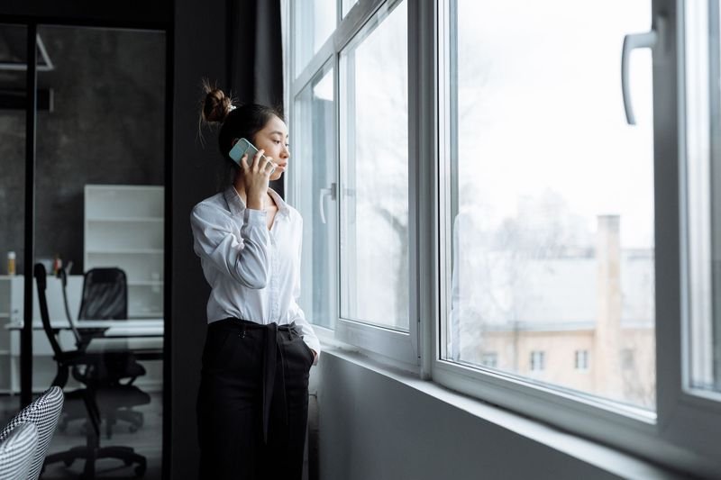 Person making a phone call at work using English