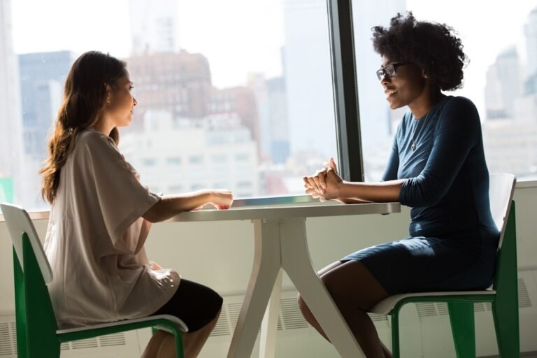 two professionals having a polite conversation about a complaint in an office setting