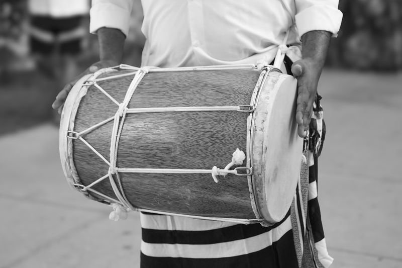 A skilled drummer playing a traditional hand drum at a cultural music event