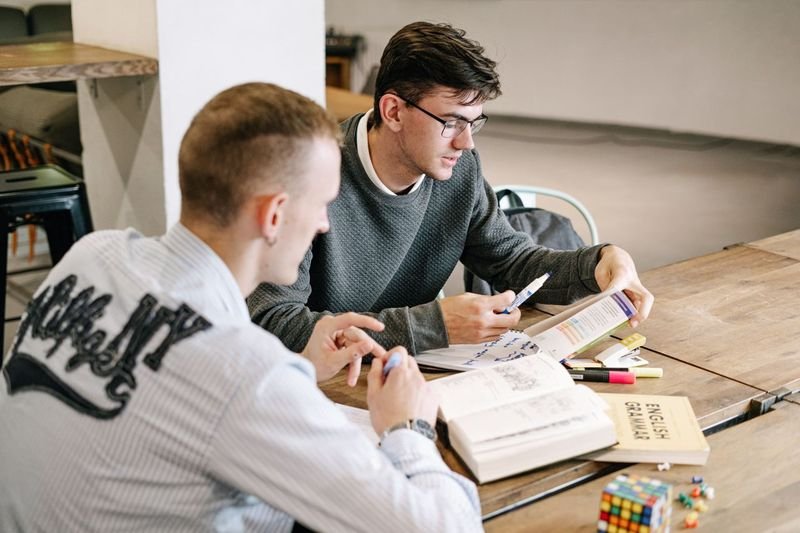 young men studying English grammar and question tags