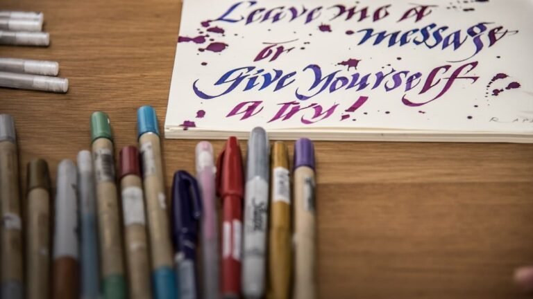 A desk with colorful pens and notebooks for studying English transition words
