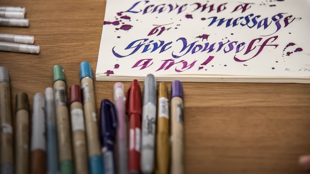 A desk with colorful pens and notebooks for studying English transition words