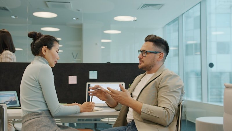 make phrasal verbs English — two colleagues celebrating an agreement at work