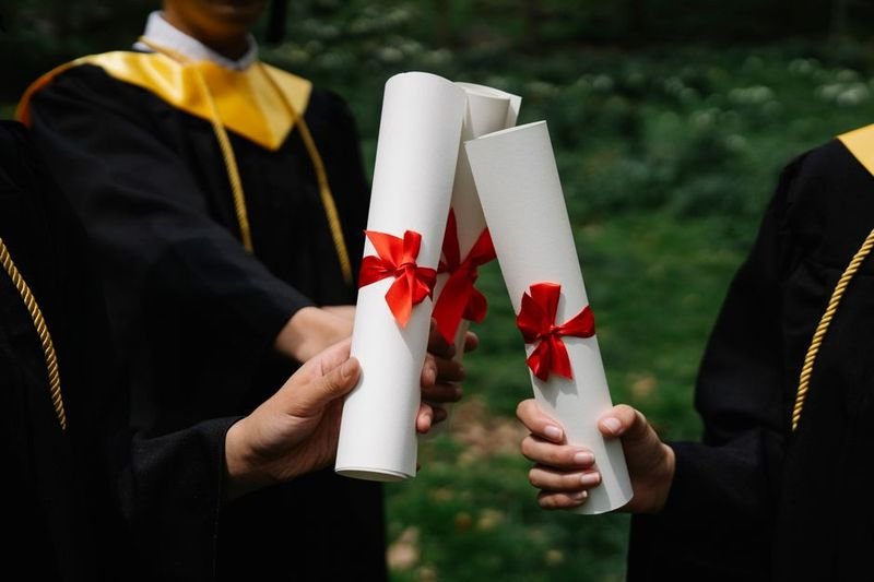 Pass with flying colors idiom — student celebrating graduation success
