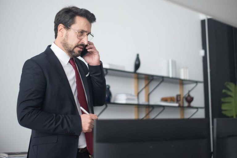 Professional making a business phone call in a modern office