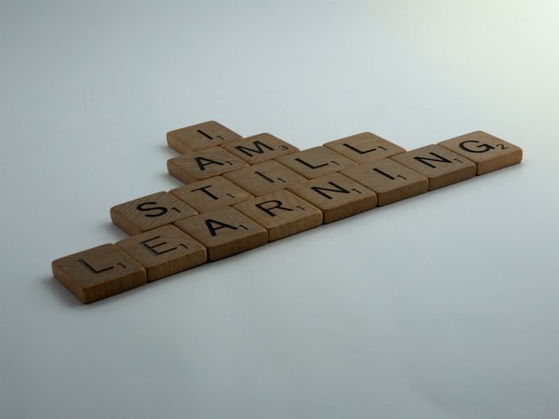 Wooden alphabet blocks on table — give up phrasal verb meaning in English (give up放棄)