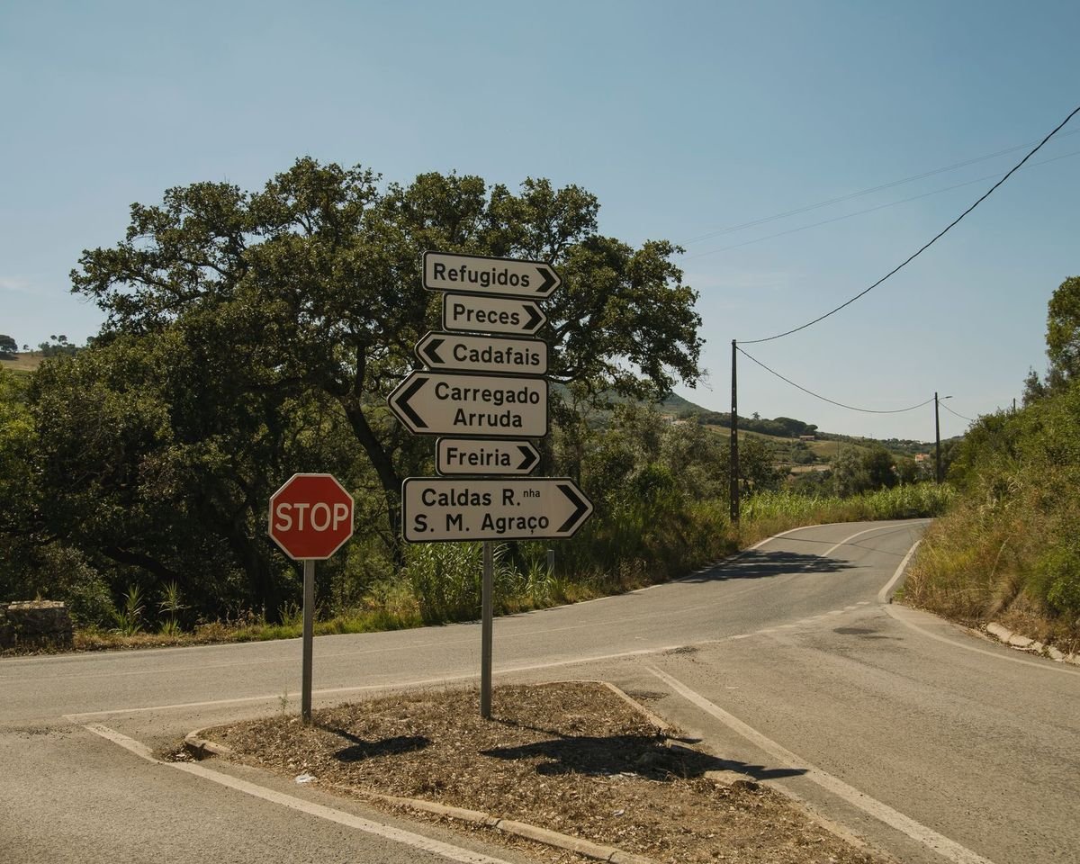 Road intersection with directional signs — phrasal verbs with TURN in English (TURN英文片語動詞)