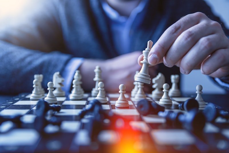 Pick your battles English idiom — chess pieces on a board representing strategic thinking
