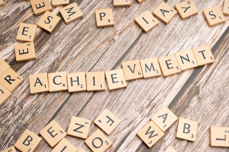 Person celebrating achievement — break through meaning in English