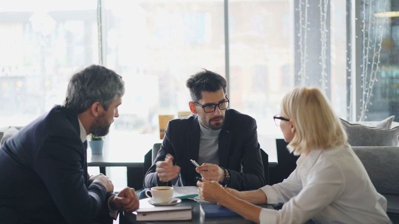 Colleagues discussing in a business meeting — reported speech at work