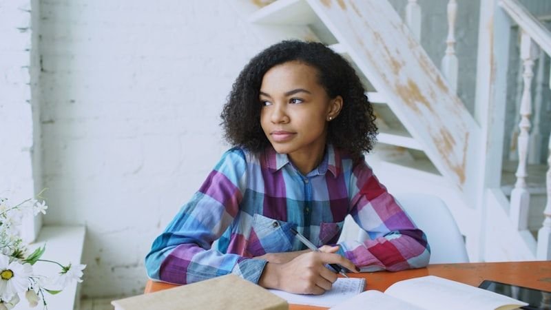 Student writing English grammar practice sentences with perfect modal verbs should have could have