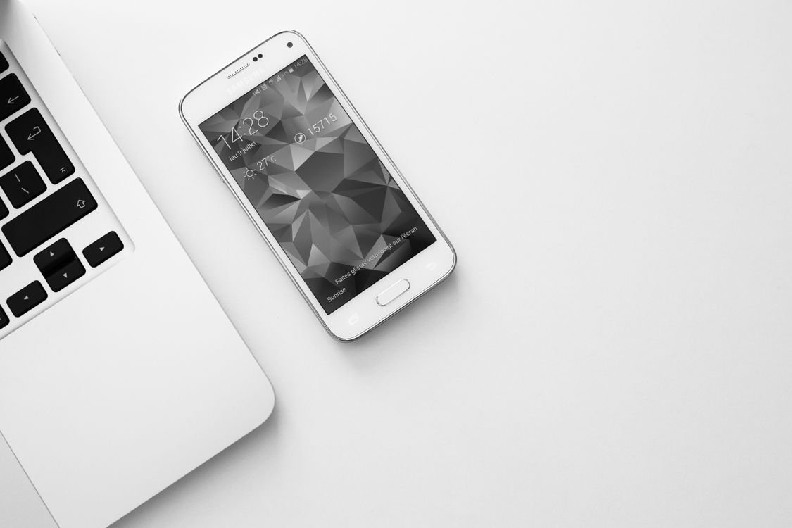 High angle shot of a laptop and smartphone on a desk