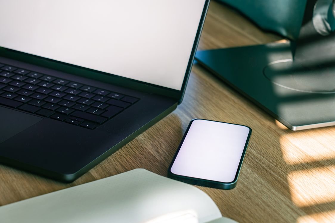 Modern office workspace with laptop and smartphone