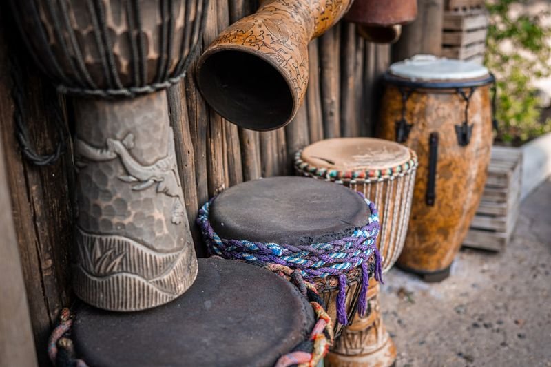 A set of handcrafted wooden drums representing traditional percussive instruments from diverse cultures